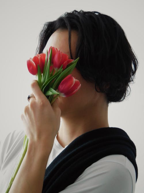 Casual Model Covering Face with Tulips