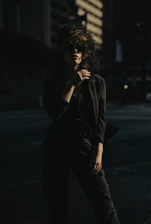 Woman in Black Clothes and Sunglasses Standing on Street
