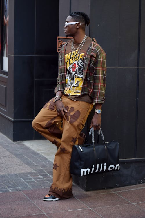 A man in a shirt and pants holding a bag