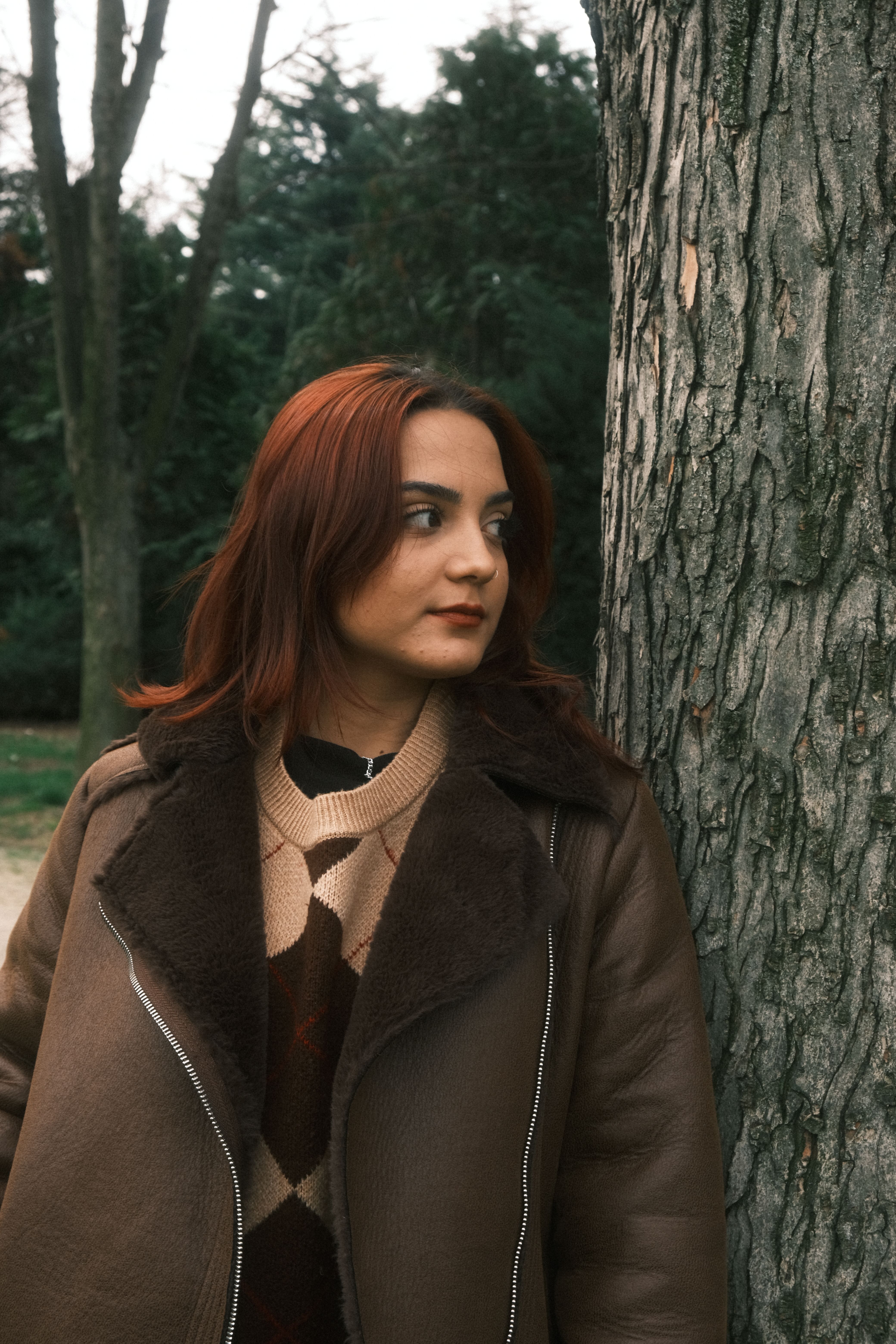 Portrait of Woman in Brown Jacket Standing by Tree · Free Stock Photo