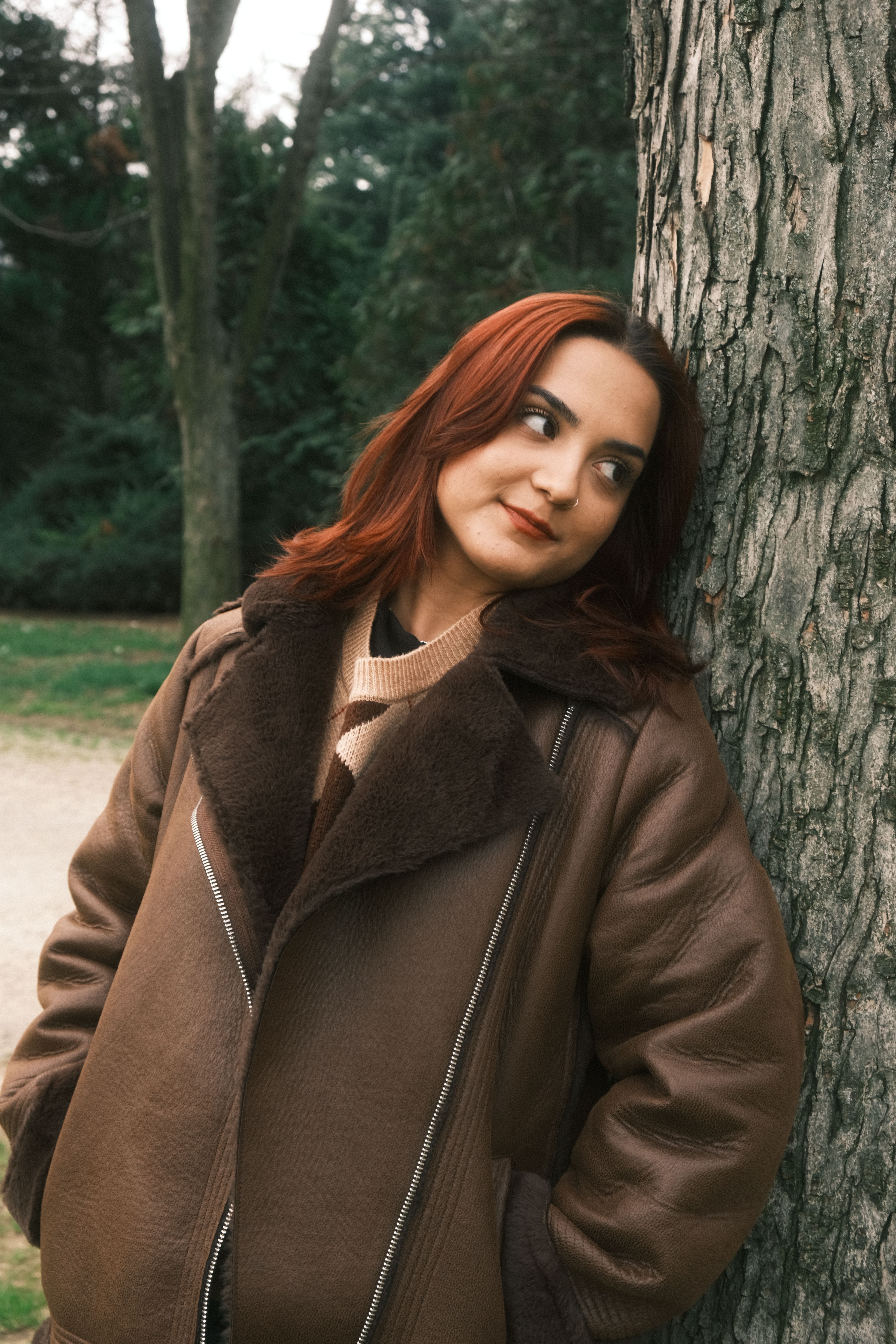 Woman in Brown Jacket Standing by Tree · Free Stock Photo