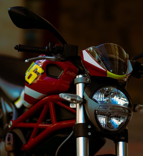 A red and black motorcycle with a yellow light