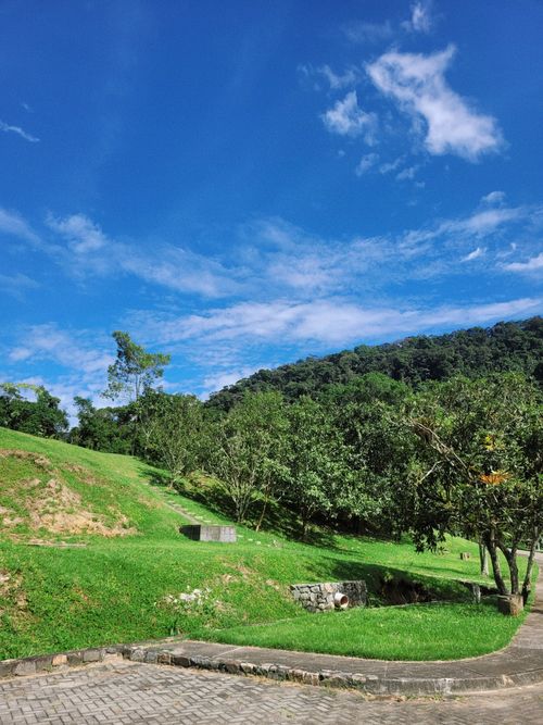 Free A beautiful rural scene showcasing lush green hills and a clear blue sky, perfect for nature photography. Stock Photo