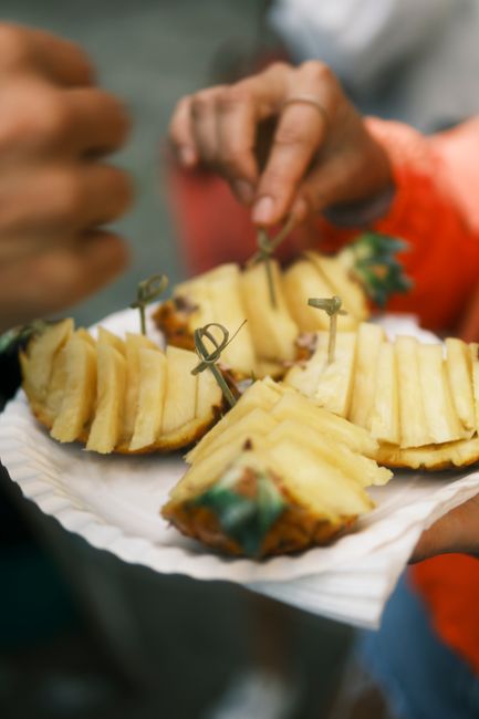 Close-up of fresh pineapple slices served on a paper plate outdoors in Azores.