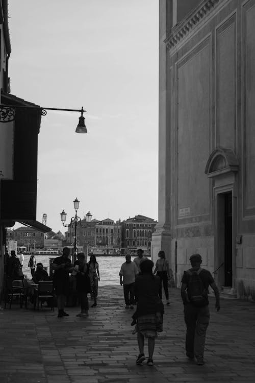 Black and white photo of people walking down a street