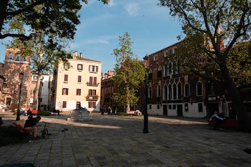 A city square with benches and trees in the background