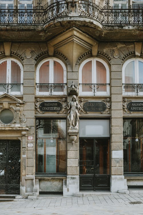A building with a statue on it and a sign that says, the best of the city
