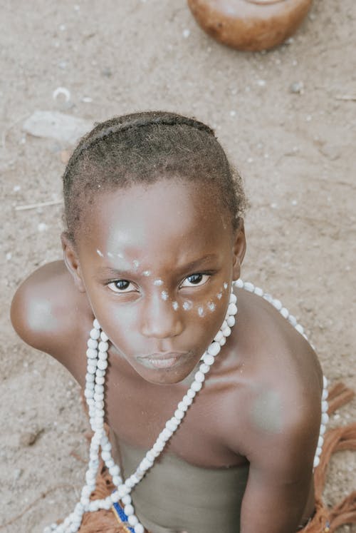 A young african girl with white face paint