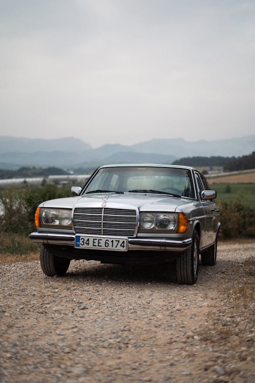 A mercedes benz parked on a gravel road