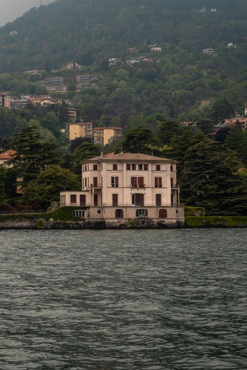Free Charming villa nestled by Lake Como surrounded by lush greenery and hills in Italy. Stock Photo