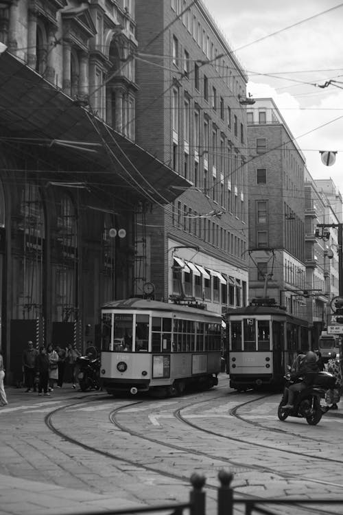 A black and white photo of a tram on a street