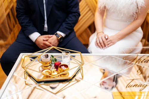 A couple sitting on a table with a tray of food