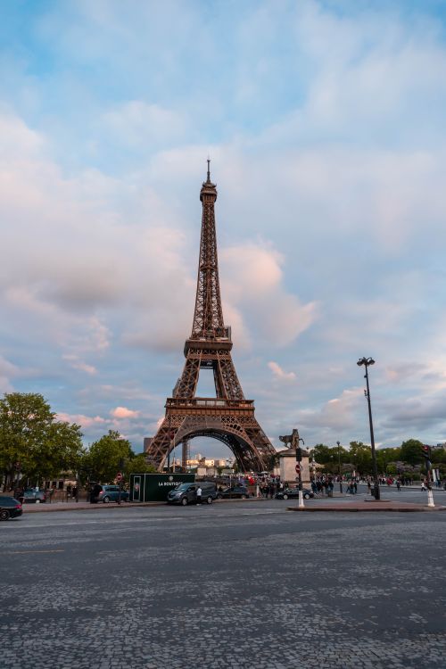 Free The iconic Eiffel Tower stands tall under a vibrant sky in Paris, France. Stock Photo