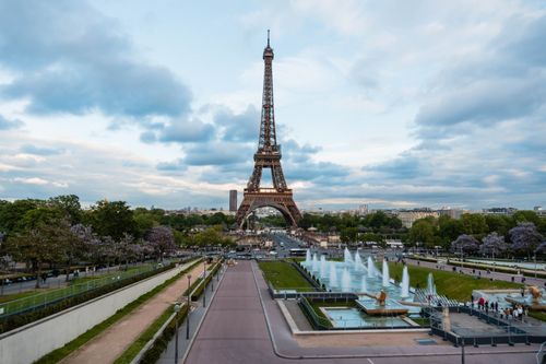 Free Aerial view of the Eiffel Tower with surrounding fountains and gardens in Paris, France. Stock Photo