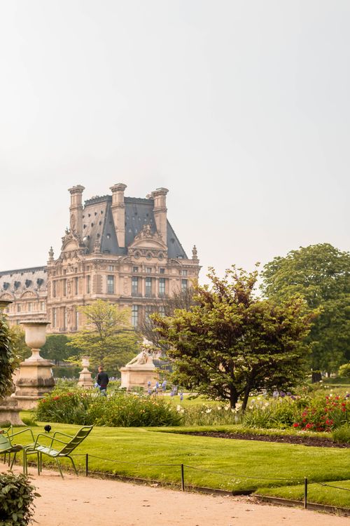 Free Explore the lush Tuileries Garden with the historic Pavillon de Flore in the background in Paris. Stock Photo