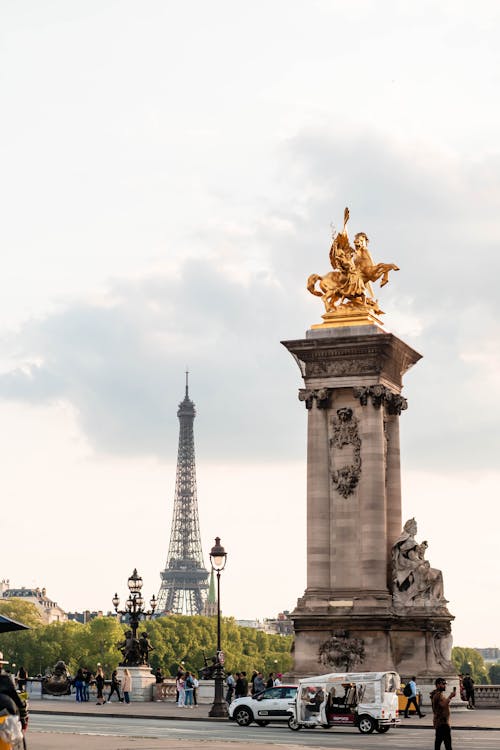 Eiffel Tower behind Golden Statue on Alexandre III Bridge in Paris