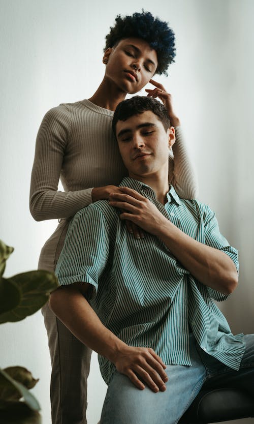 A man and woman sitting on a couch together