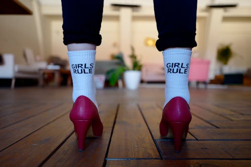 Person Wearing Pair of White Girls Rule Text-printed Socks