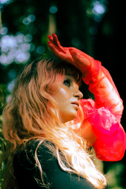 Portrait of Blonde Woman with Arm Raised in Glove