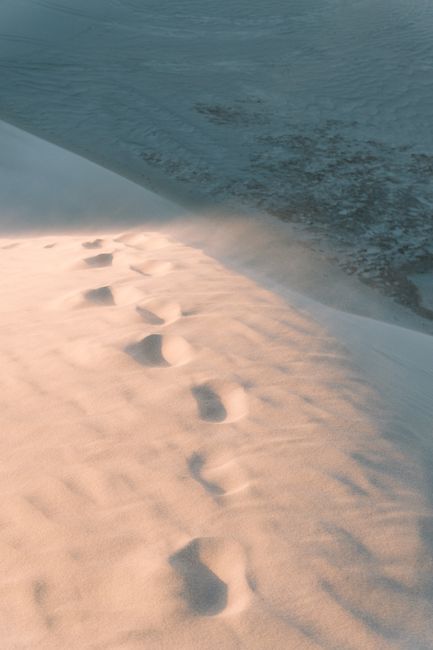 Tranquil footprints on Lancelin sand dunes in Western Australia during sunset.