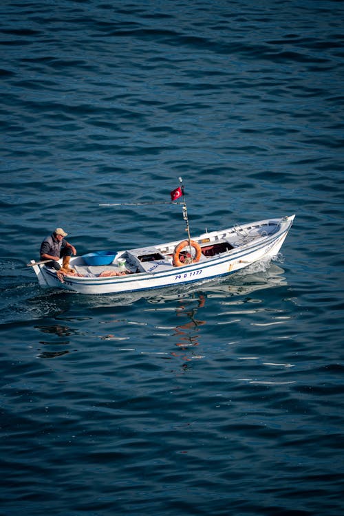 Fisherman Sitting on Motorboat