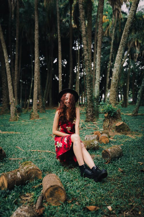 A woman sitting in the middle of a forest