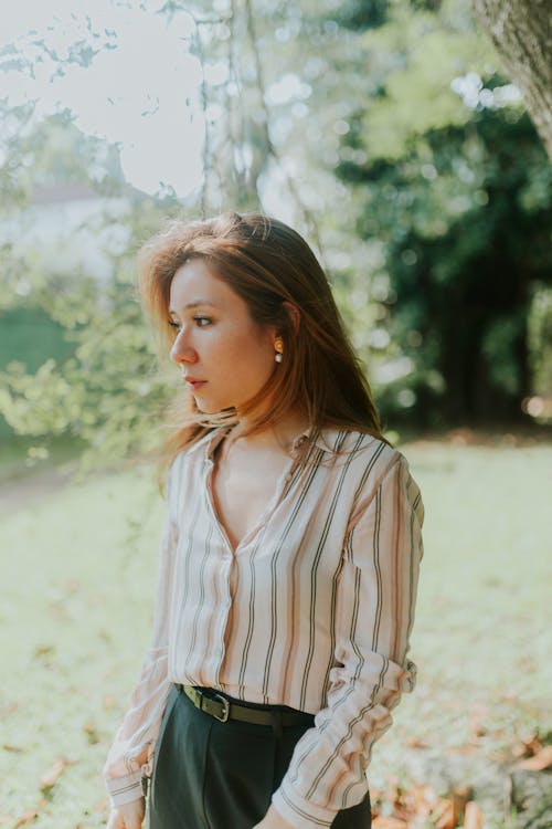 A woman in a striped shirt and black pants