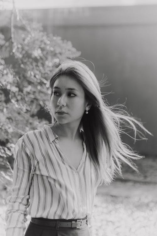 A woman in a striped shirt and skirt