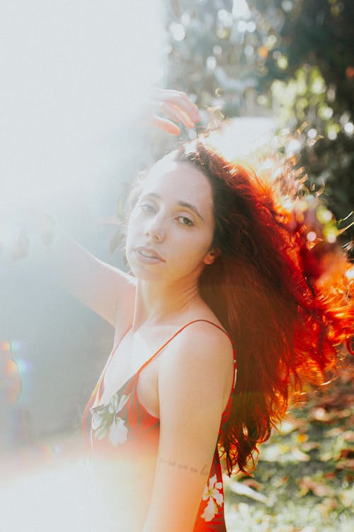 A woman with red hair and a red dress