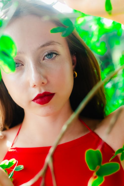 A woman in red dress with green leaves