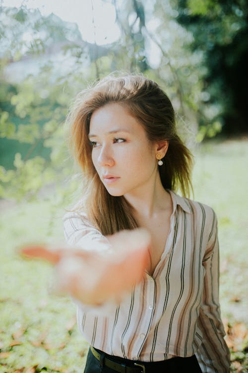 A woman is pointing at something in the air