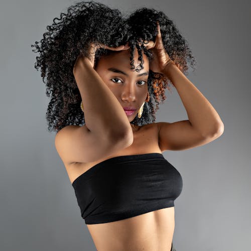 A woman with curly hair posing for a photo