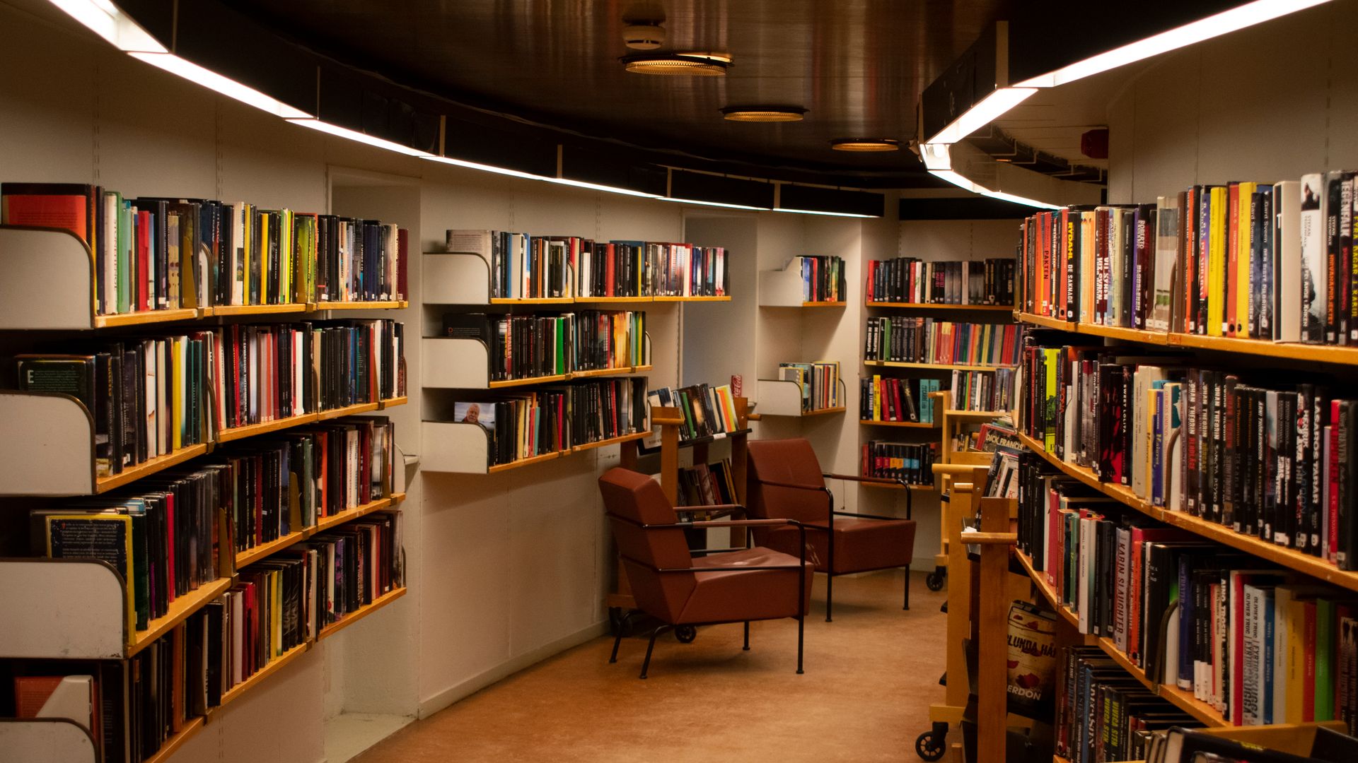 Grand historic library reading room lined with books