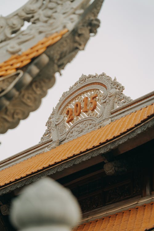 A close up of a chinese temple with a gold roof