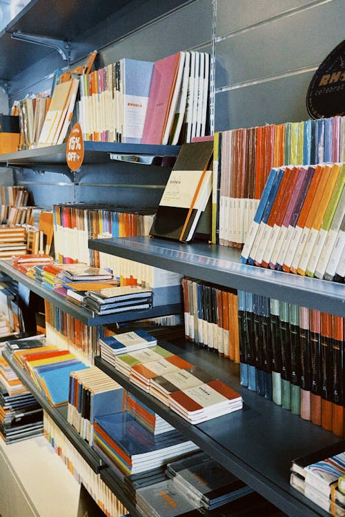 Books Displayed on Shelves in a Bookstore 