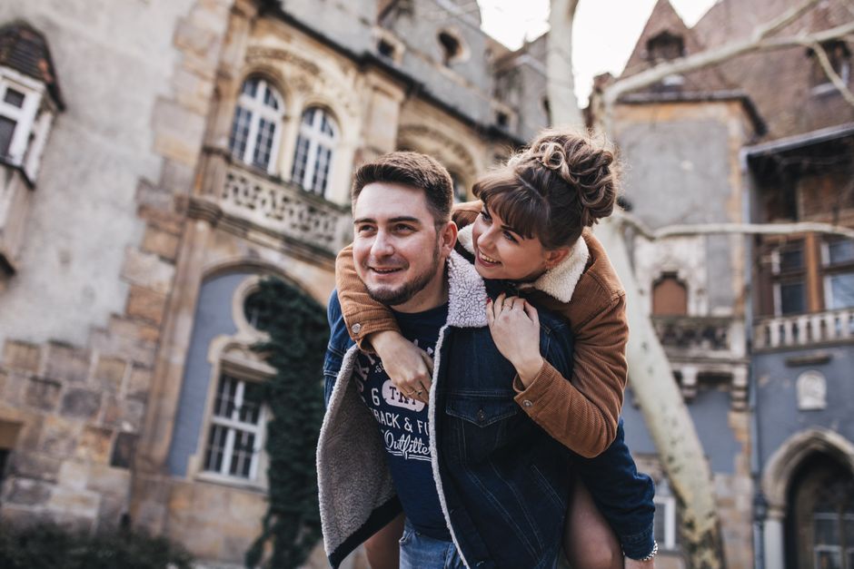 Smiling couple having fun together outdoors in an urban setting.