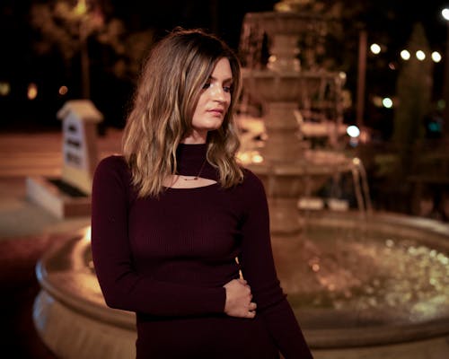 Portrait of Woman near Fountain at Night