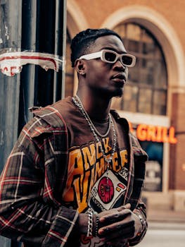African model wearing fashion-forward attire poses against an urban backdrop in Atlanta.