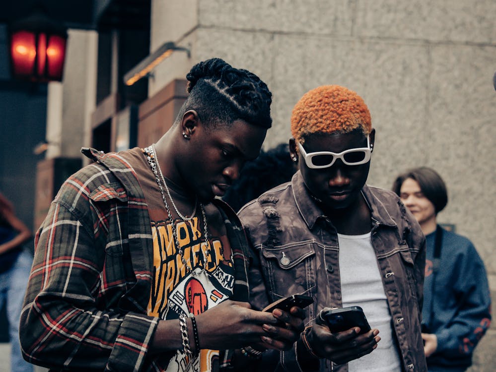 Black fashion models looking at their phones 