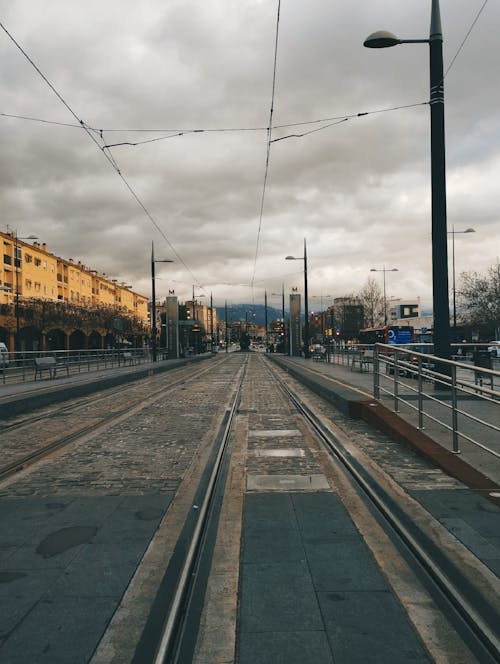 A train track with a city street in the background