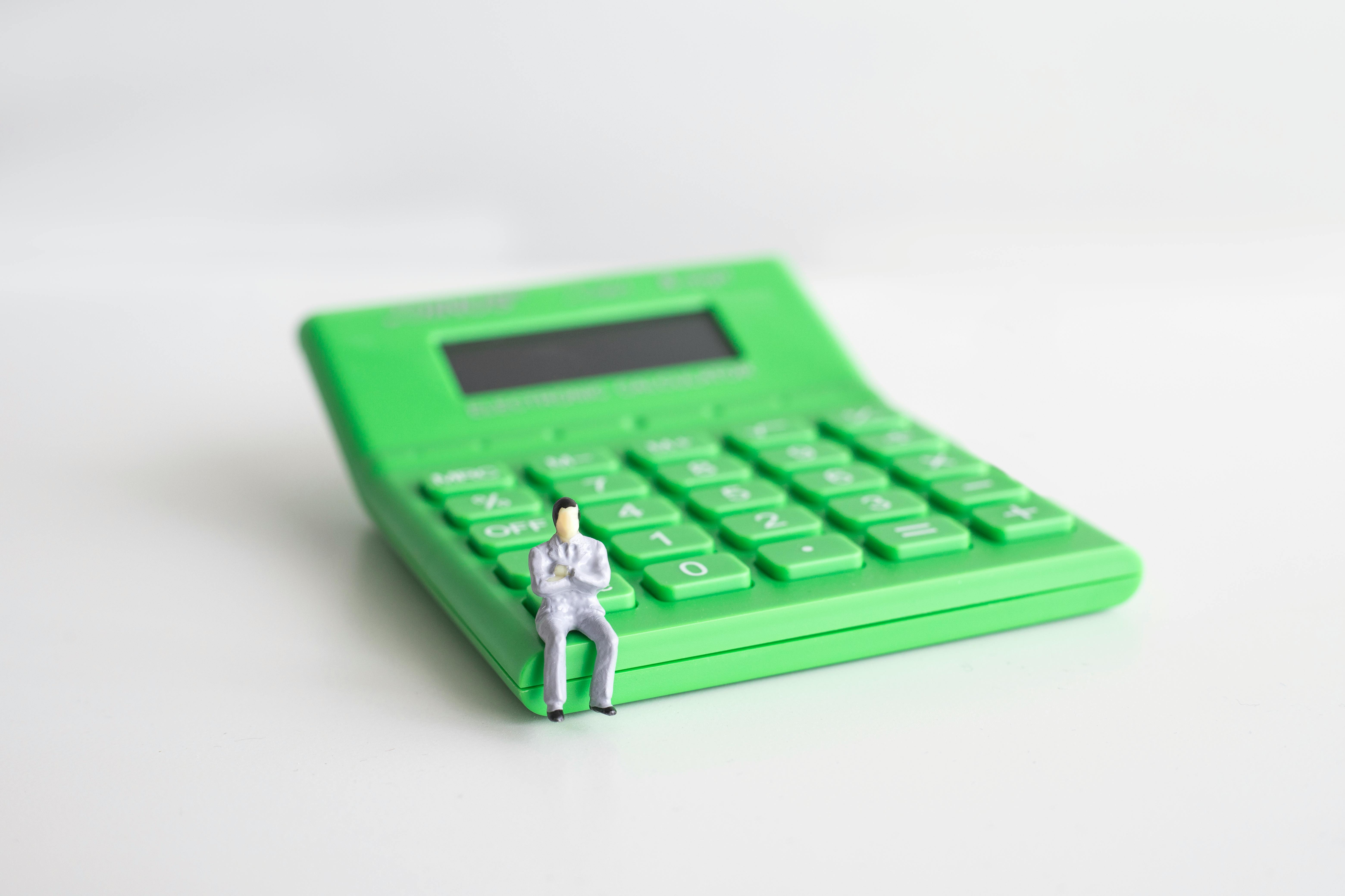 a miniature figure on a calculator