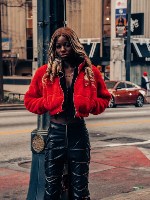 black fashion model posing in red jacket 