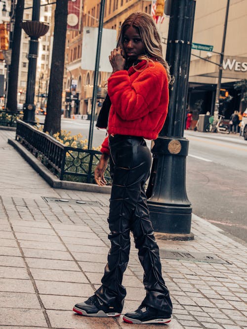 Black fashion model posing in red jacket 