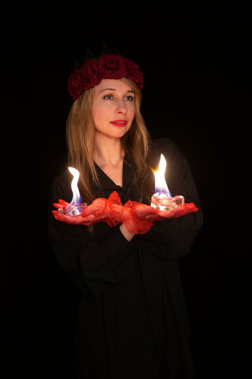 A woman holding two candles in her hands