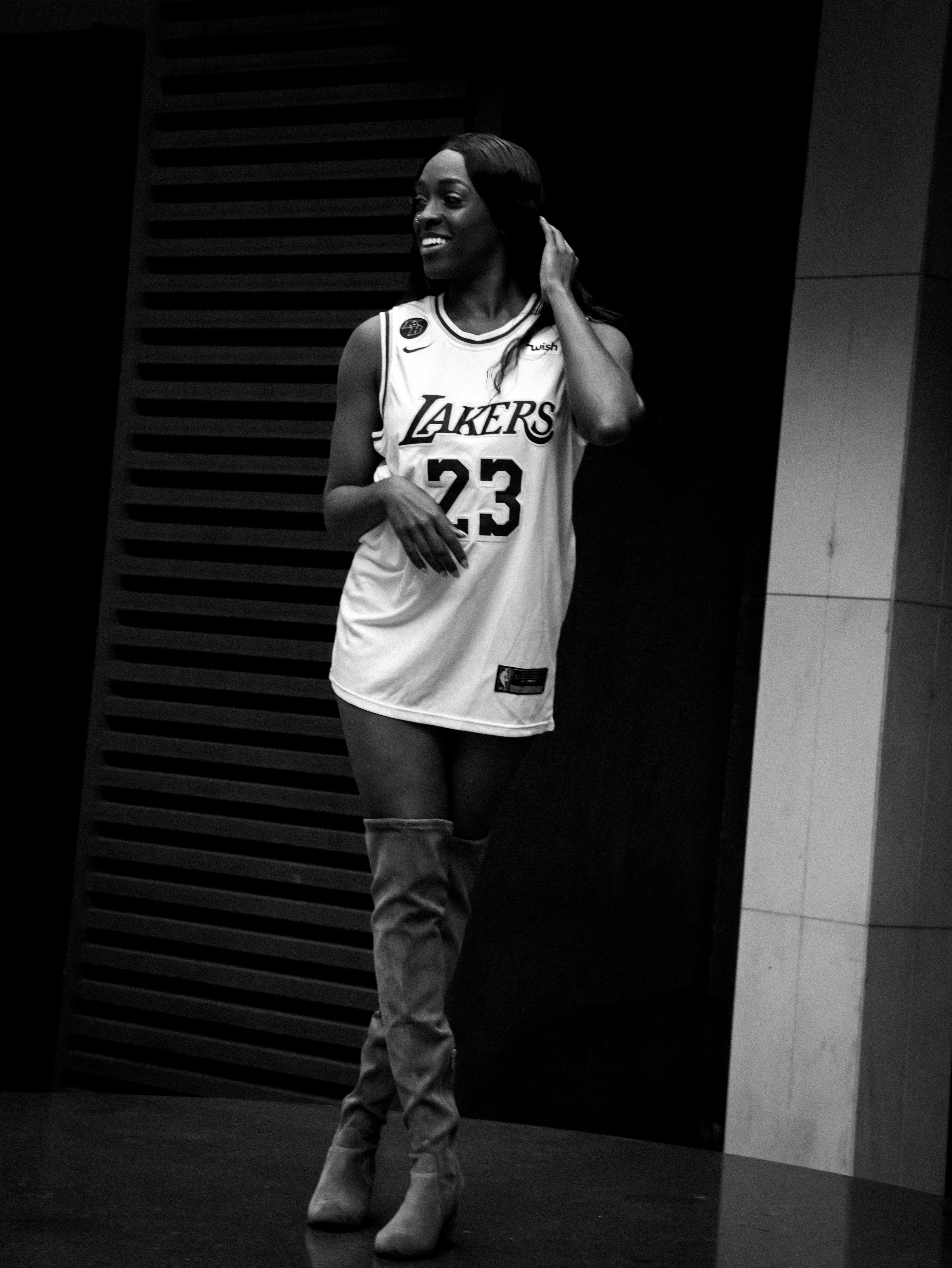 beautiful black fashion model smiling in basketball jersey