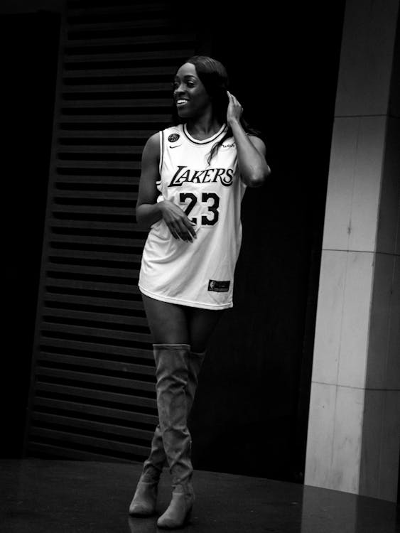 Beautiful black fashion model smiling in basketball jersey 