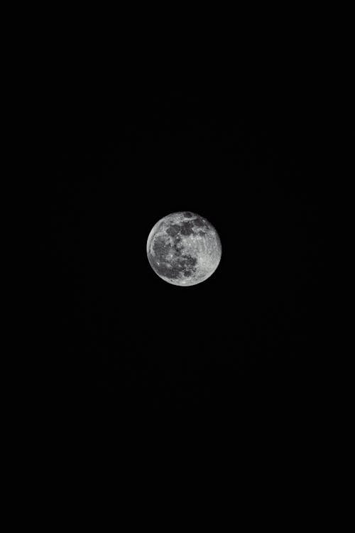 A full moon is shown in the dark