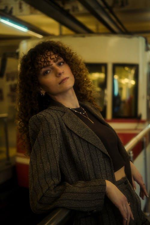 A woman with curly hair posing for a photo