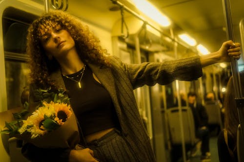 A woman holding flowers on a subway train