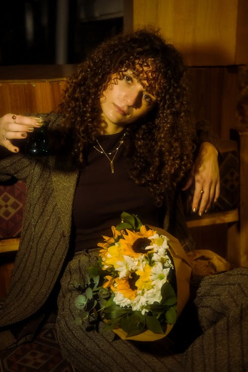 Woman Sitting with Flowers Bouquet